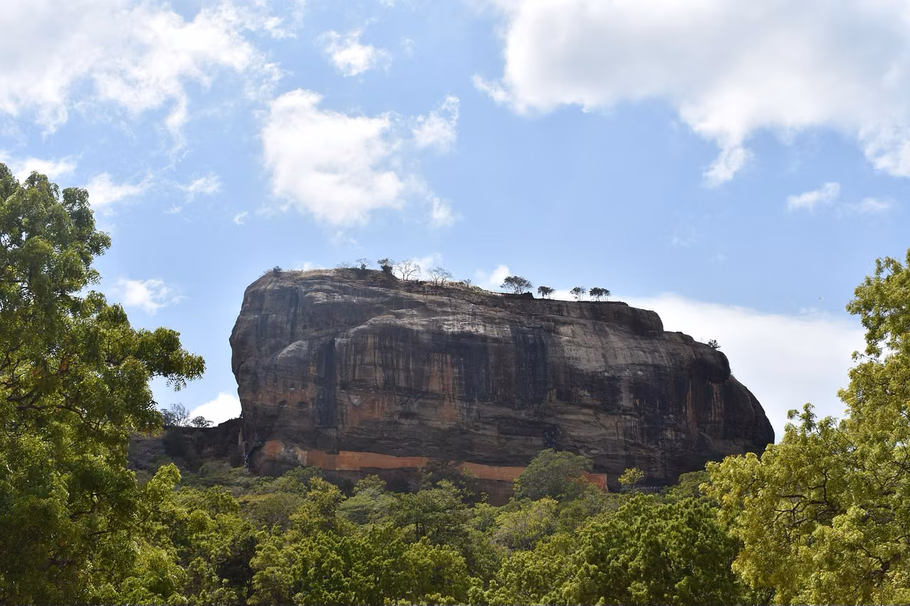 Sigiriya Lion Rock Fortress rising 200m above lush green jungle canopy in Sri Lanka